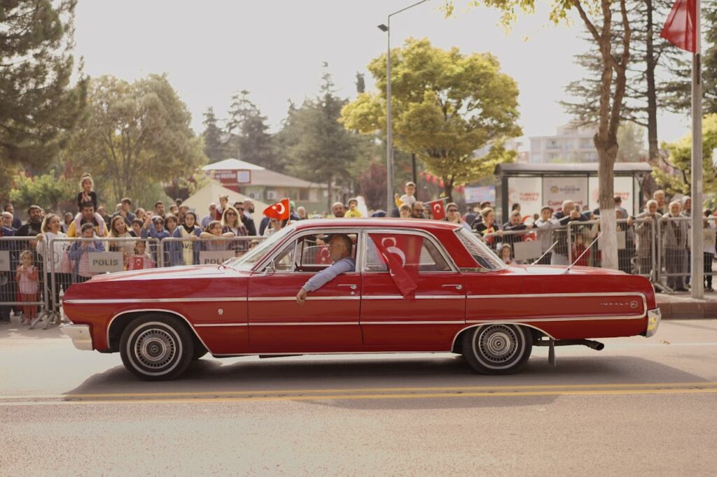 pexels-photo-19021097 Man Driving Vintage Chevrolet Impala at Parade